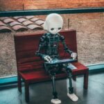 black and white robot toy on red wooden table